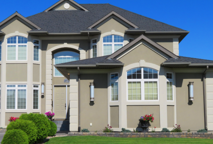 A large house with a lawn in front of it.