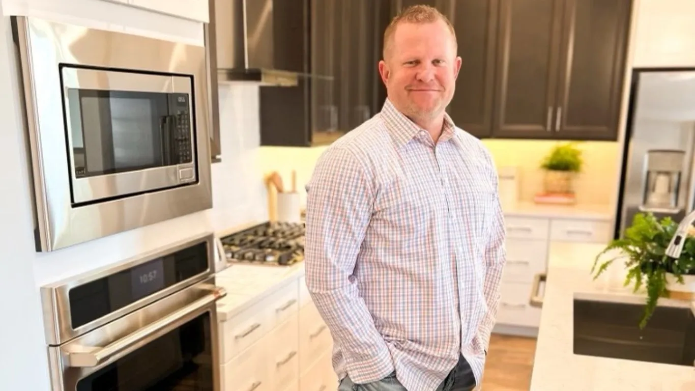 A man standing in front of an oven.